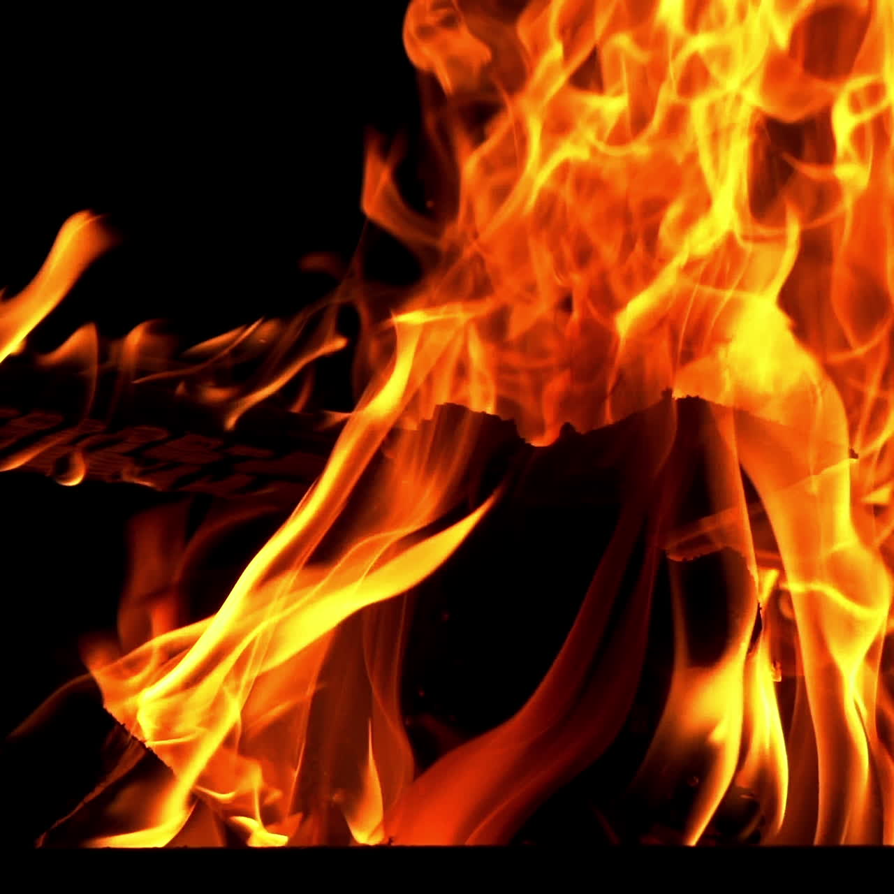 Hot coals in the fire. Fire flames on black background. Slow motion