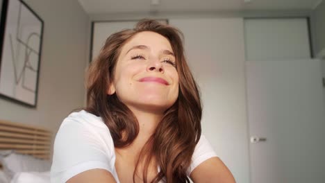 happy woman stretching in bed after wake up