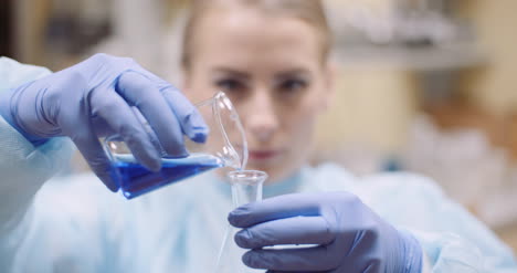 Scientist-Mixing-Liquid-At-Laboratory-1