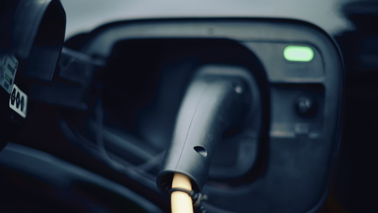Electric vehicle plugged into charging port in daylight
