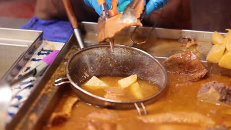 street vendor cooking traditional hong kong dish