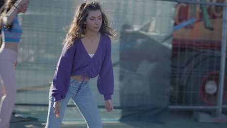 young woman dancing in front of a vintage circus truck