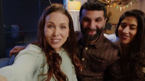 pov shot of friends dressing up with irish novelties and props at home or in bar posing for selfie celebrating at st patrick's day party in real time