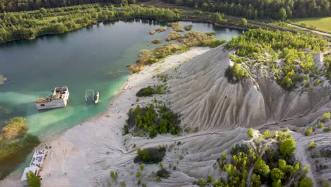 Aerial-landscape-Sand-Hills-of-Quarry-With-a-Pond-and-Abandoned-Prison-in-Rummu-Estonia-Europe