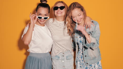 three happy women posing together