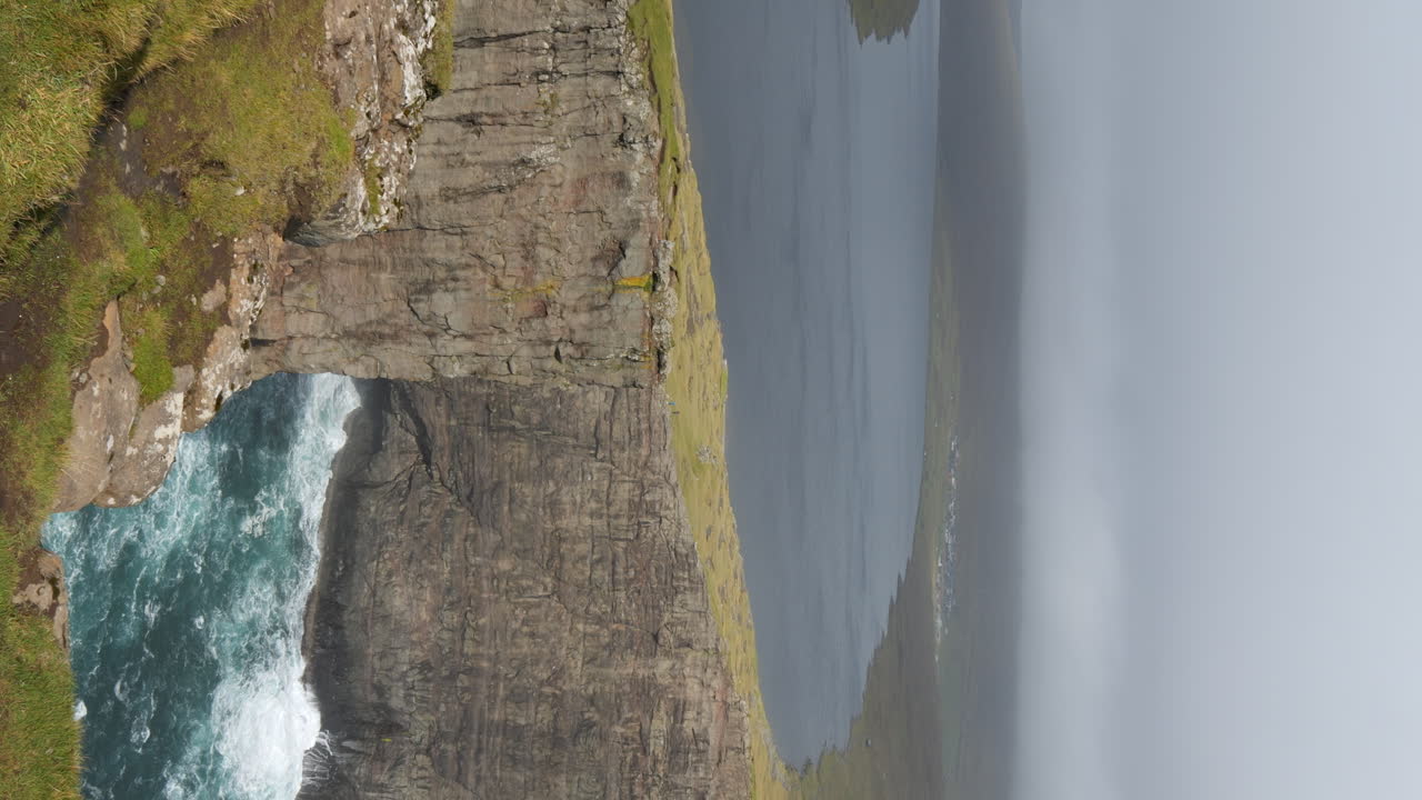 Vertical - Rock Formation Surrounding Lake Sorvagsvatn In Fog. Vagar Island, Faroe Islands.