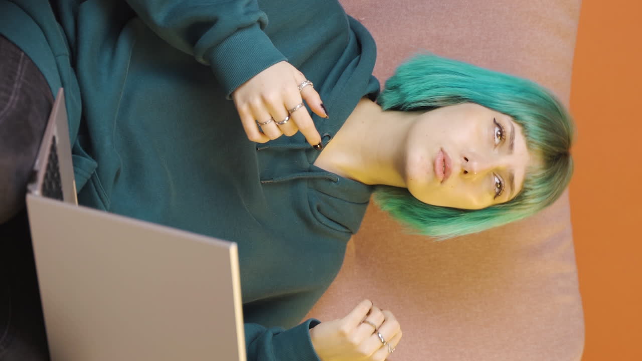 Vertical video of Confused young woman thinks and can't figure it out.