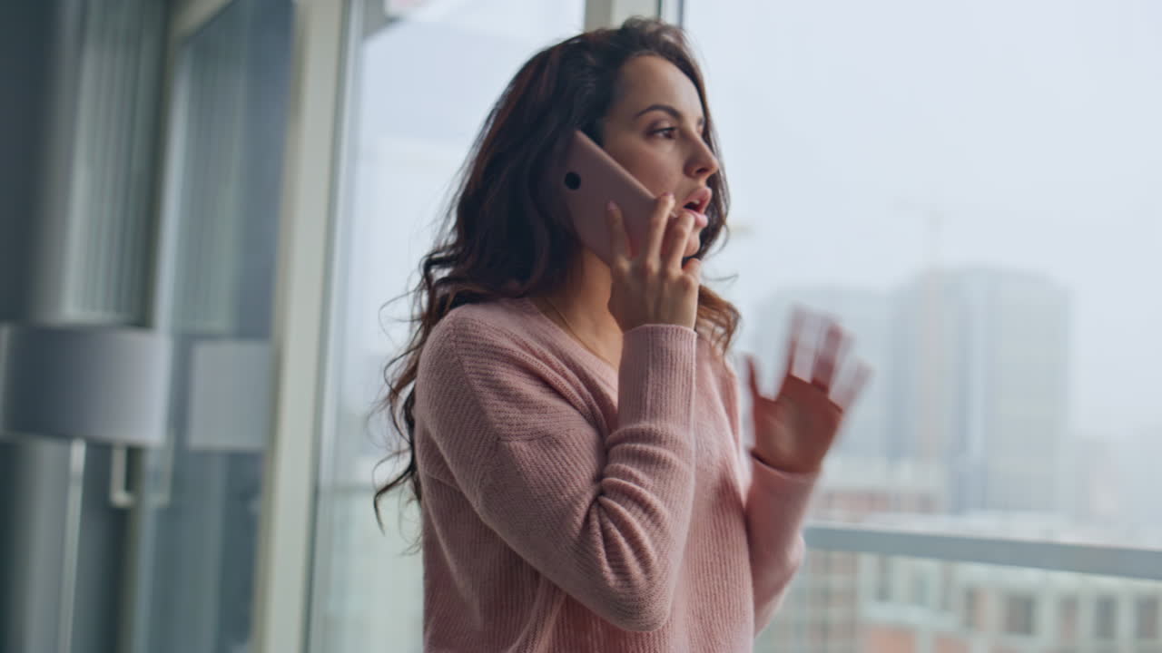 Annoyed client making order online speaking smartphone at cityscape flat closeup