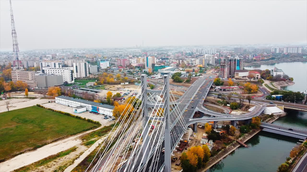 Ciurel passage, bridge over a river with moving cars, construction works near it. View from the drone. Bucharest, Romania
