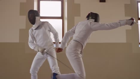 Fencer-athletes-during-a-fencing-training-in-a-gym