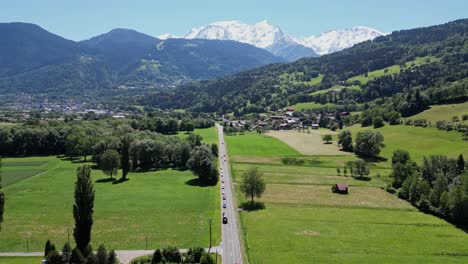 cars driving scenic road to mont blanc in french alps - aerial dolly forward