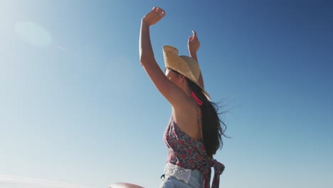 Happy-caucasian-woman-sitting-on-beach-buggy-by-the-sea-waving-hands