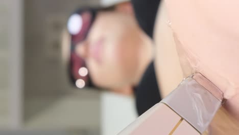 person undergoing a facial treatment with a vacuum device