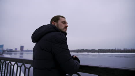 long-haired guy outdoors in a cold day