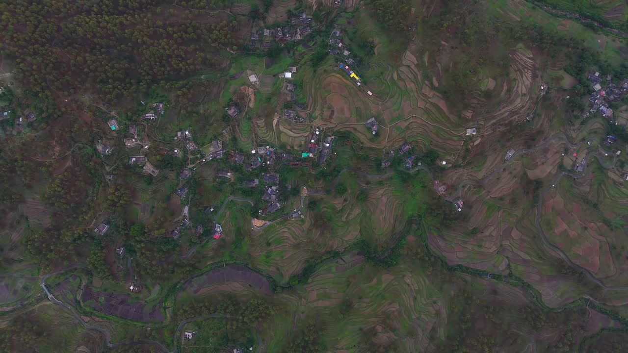 Aerial drone shot showcasing the soft golden glow of morning over mist-covered hills.