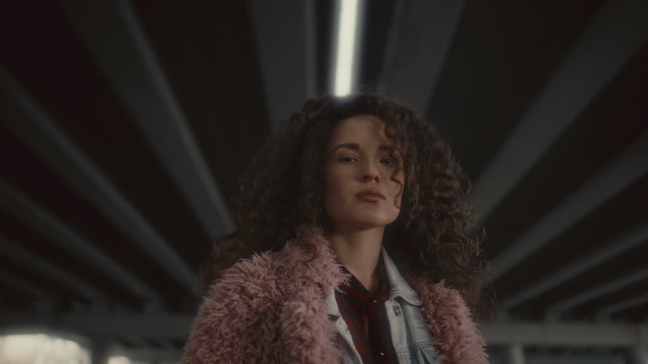 Portrait of Young Pretty Woman in Stylish Outfit under Urban Bridge