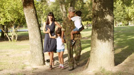 military man spending park day with family