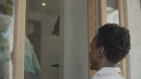 closeup of black gay couple climbing stairs and entering shop.