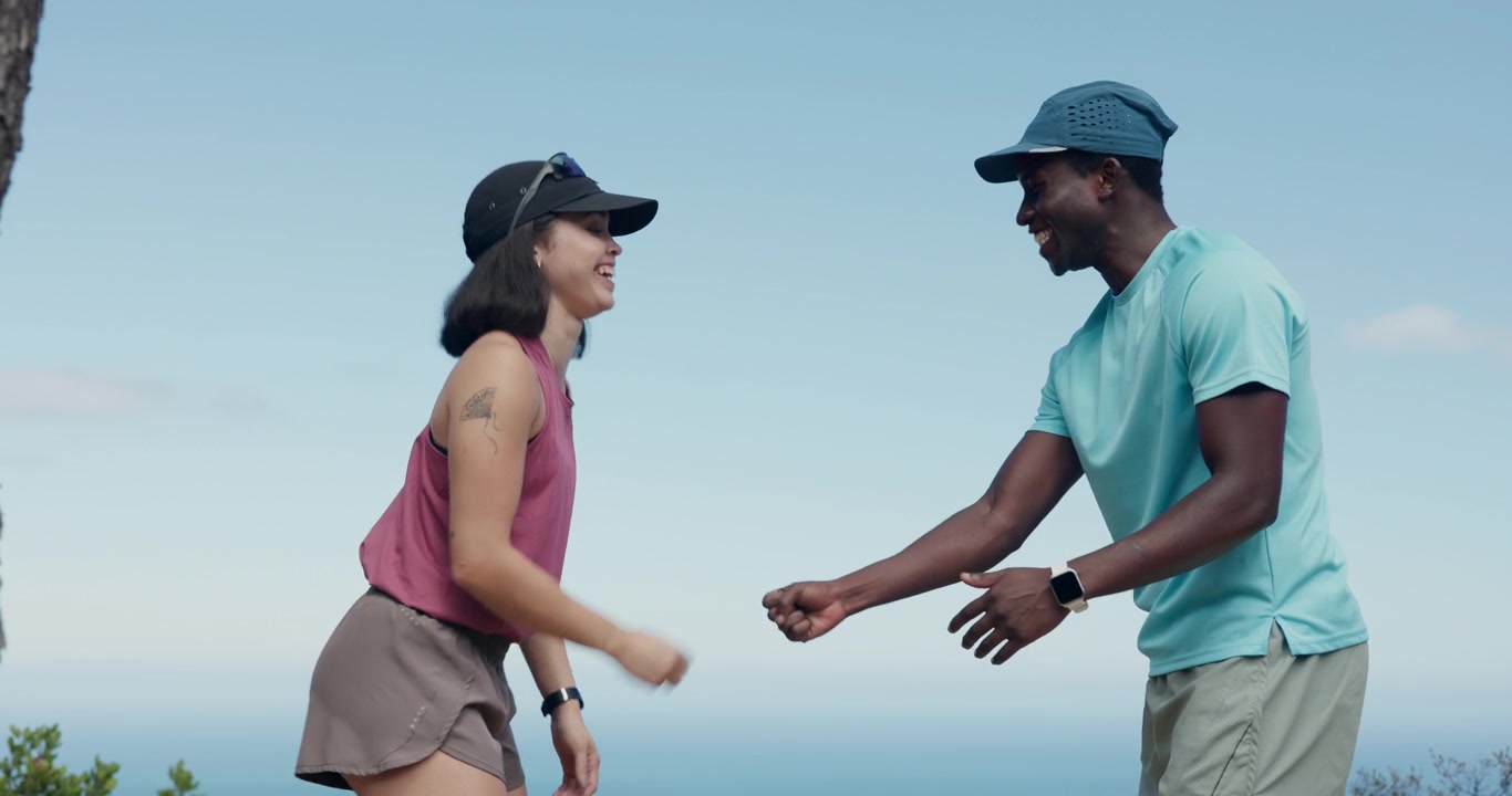Active Couple High-Fiving and Resting After Outdoor Exercise