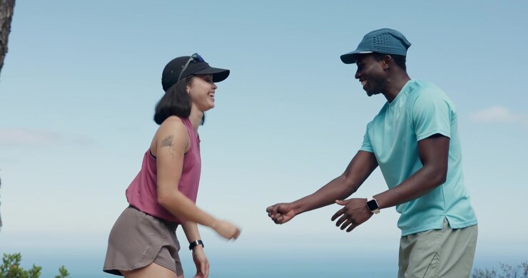 Active Couple High-Fiving and Resting After Outdoor Exercise