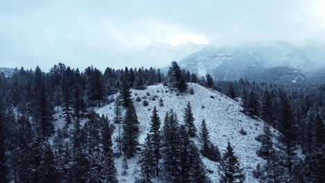 Flying-over-snowy-hill-in-the-mountains-in-winter