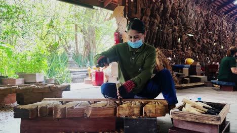 skillful female wood carver creates intricate wooden sculptures