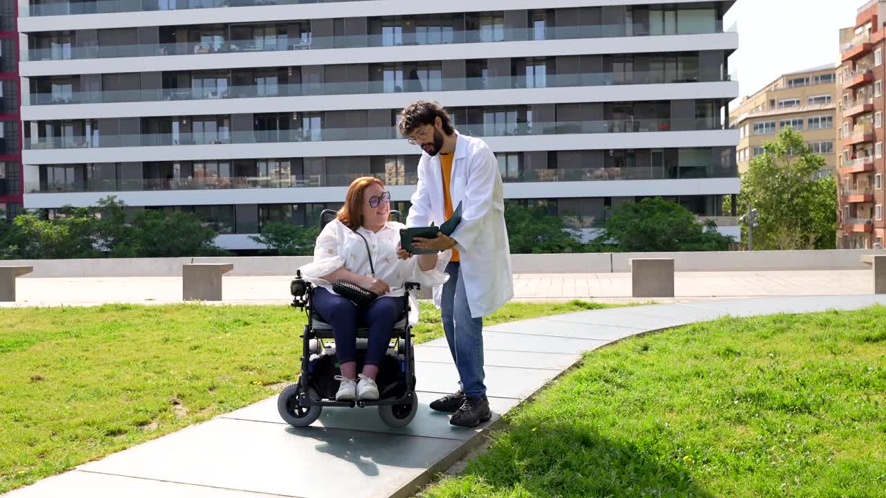 Doctor consulting with patient in wheelchair