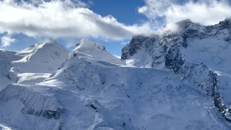 Incredible-stunning-morning-Gornergrat-Zermatt-Glacier-glacial-peaks-ice-crevasse-river-Swiss-Alps-Matterhorn-summit-ski-resort-landscape-scenery-aerial-drone-autumn-Railway-Switzerland-pan-left