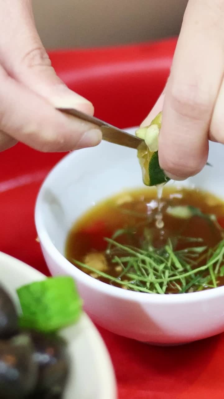 Hands garnishing and seasoning a small bowl