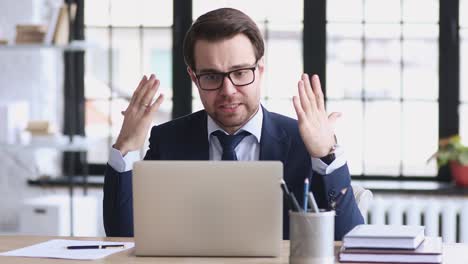 angry stressed businessman wearing suit feeling mad about broken laptop