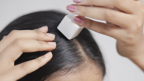 one woman using derma stamp on alopecia head to stimulate hair follicle, hair care concept.