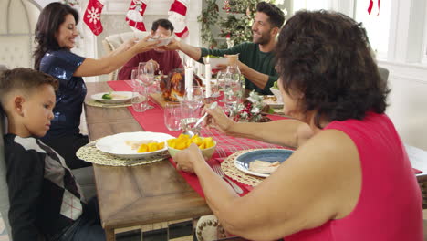 family with grandparents enjoying christmas meal shot on r3d