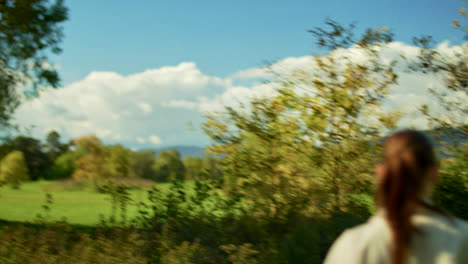 woman in a beige jacket in a forest