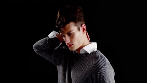 Androgynous-man-posing-against-black-background