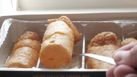 golden syrupy chachepo sweets in plastic tray, traditional from linares, jaén, spain