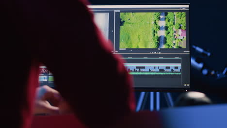 Video-editor-analyzing-film-montage-before-editing-color-grading-and-lighting-in-creative-office