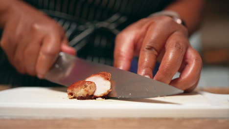 Slicing-pan-fried-boneless-chicken-breast-for-a-homemade-meal---slow-motion