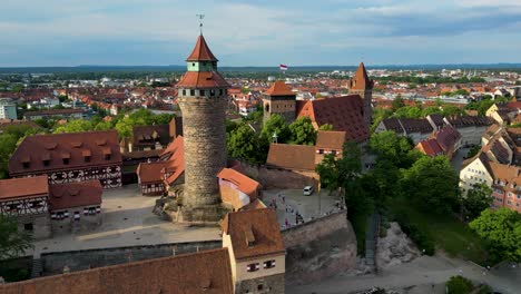 4k aerial drone video of the heathens' tower, sinwell tower, and historic homes around the kaiserburg nürnberg imperial castle in downtown nurnberg, germany
