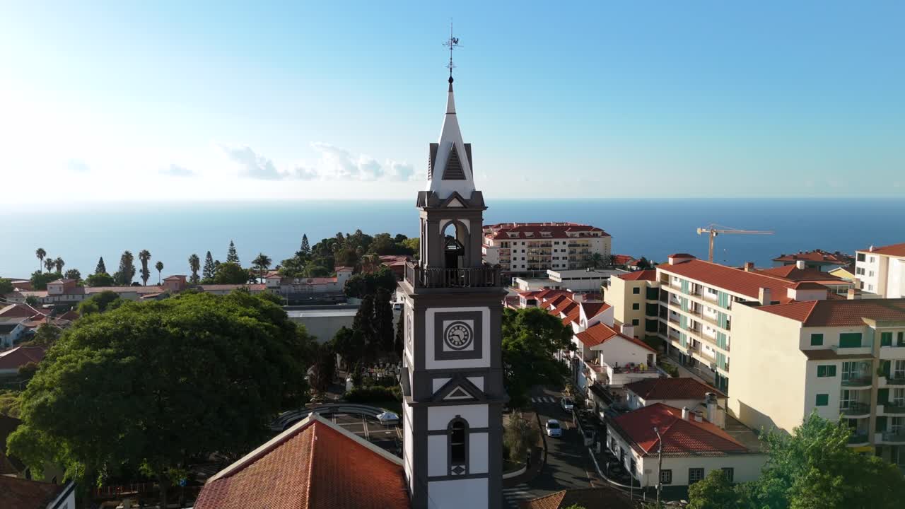 Drone orbit flying around Igreja Matriz do Canico parish church bell tower, Madeira