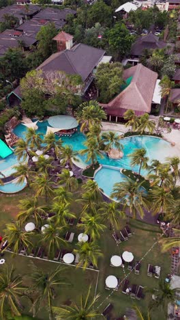 a peaceful tropical pool surrounded by lush greenery and warm sunlight in seminyak bali invites a relaxing moment under the open sky perfect for a refreshing swim or a calm escape