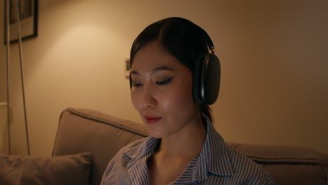 woman relaxing on a couch listening to music