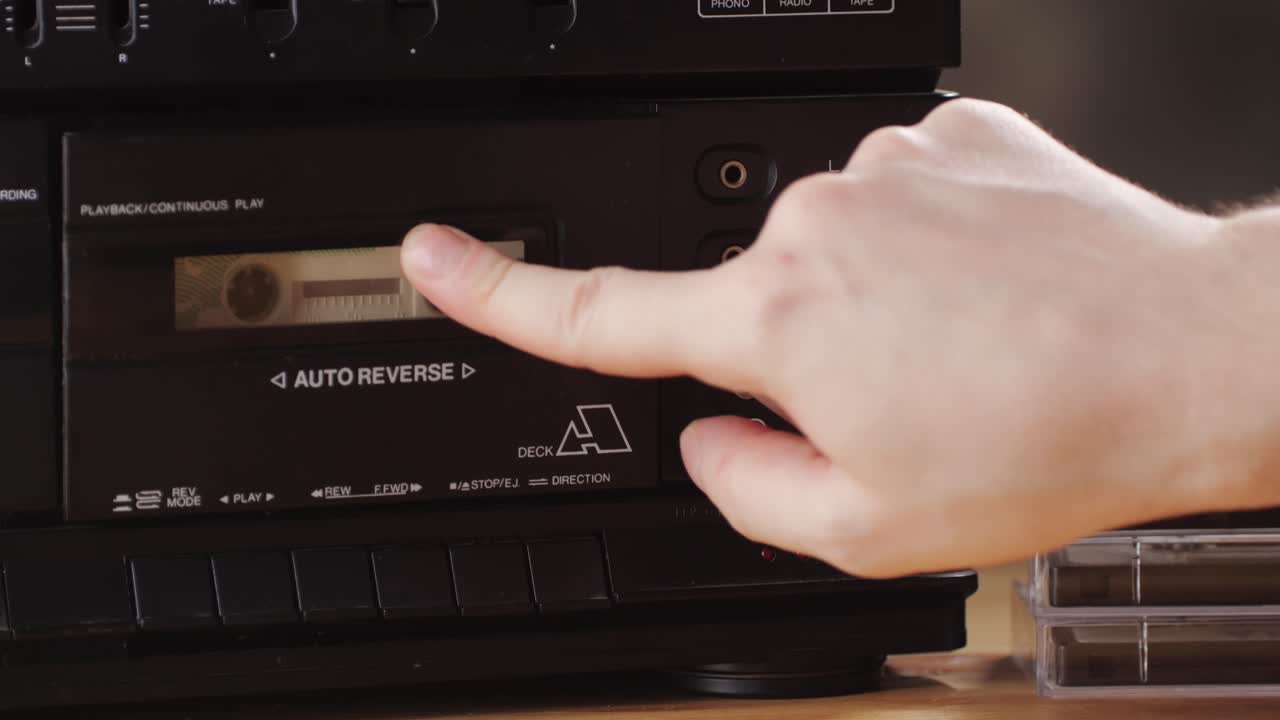 Retro radio tape recorder, audio cassette close-up. Listening to music, old radio boom box player, macro of vintage music listening.