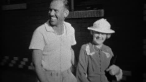 1935: blue collar gentleman escorting formal fancy women with dog.