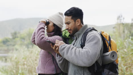 Couple,-hiking-and-cellphone-with-location-search