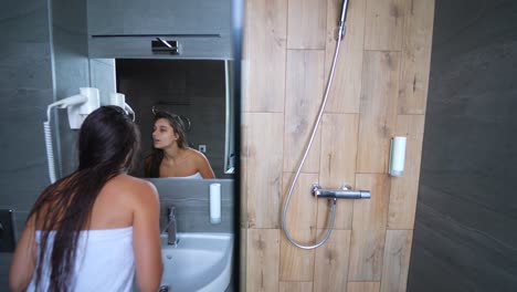 woman getting ready in a hotel bathroom