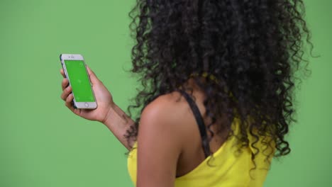 young beautiful hispanic woman using phone