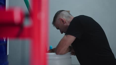 man working on plumbing in a facility