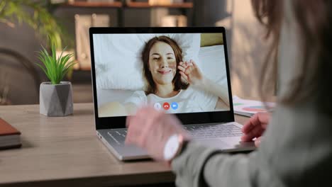 Female-Videochatting-With-Friend-On-Laptop-While-Sitting-Indoors