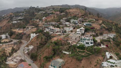 aerial wide rising shot of las flores canyon in malibu after the palisades fire in los angeles, california. 4k