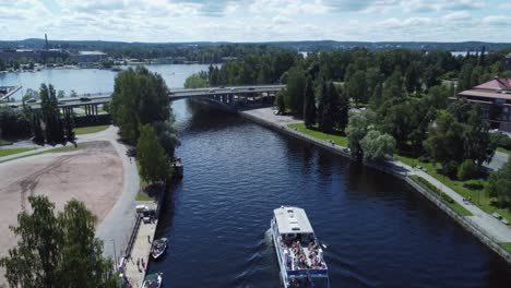 low aerial follows tourist tour boat in tampere finland water canal